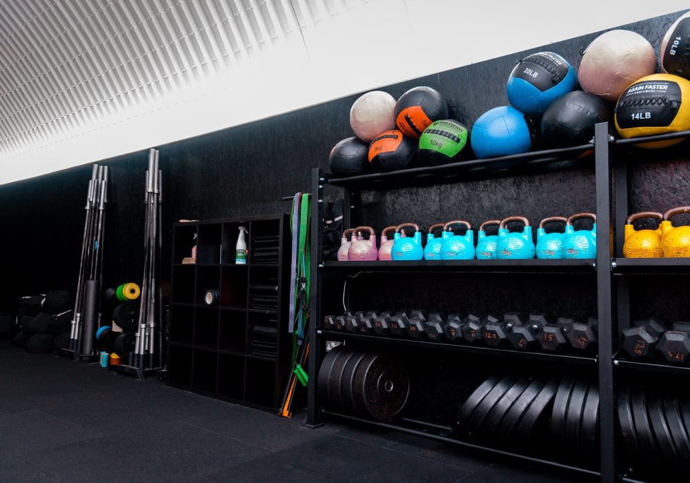 Weighted equipment for Hyrox training including medicine balls, kettlebells and sandbags